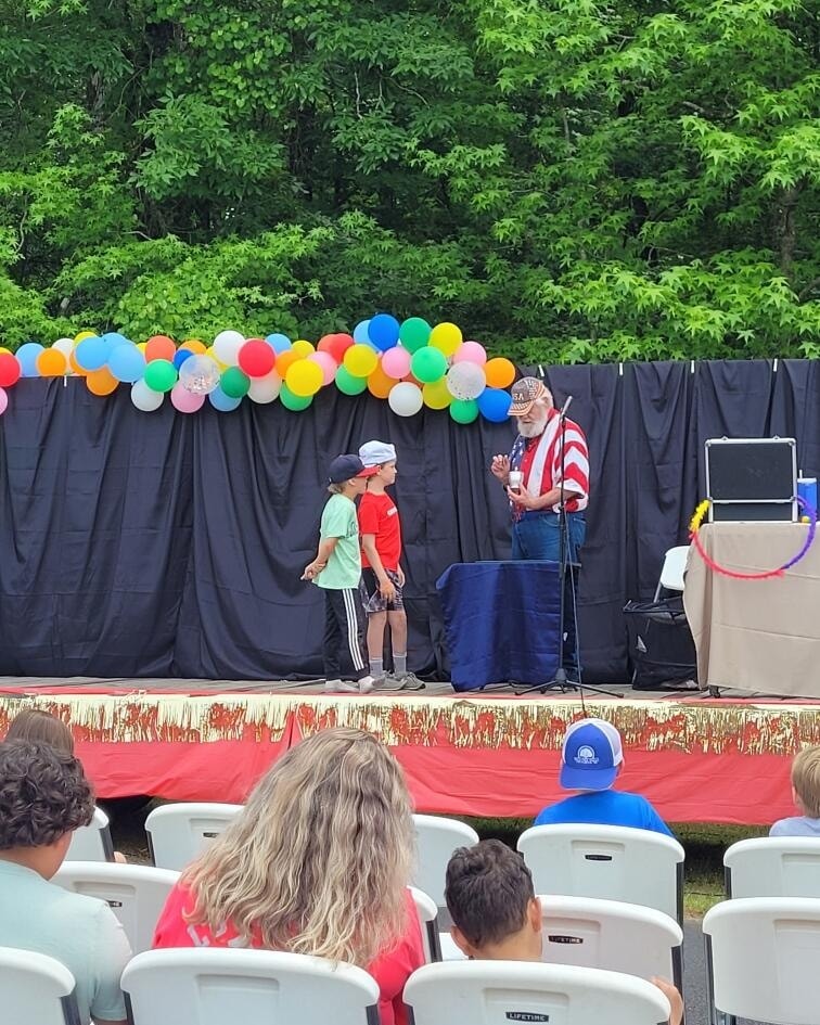 Magician performing for students at a school assembly