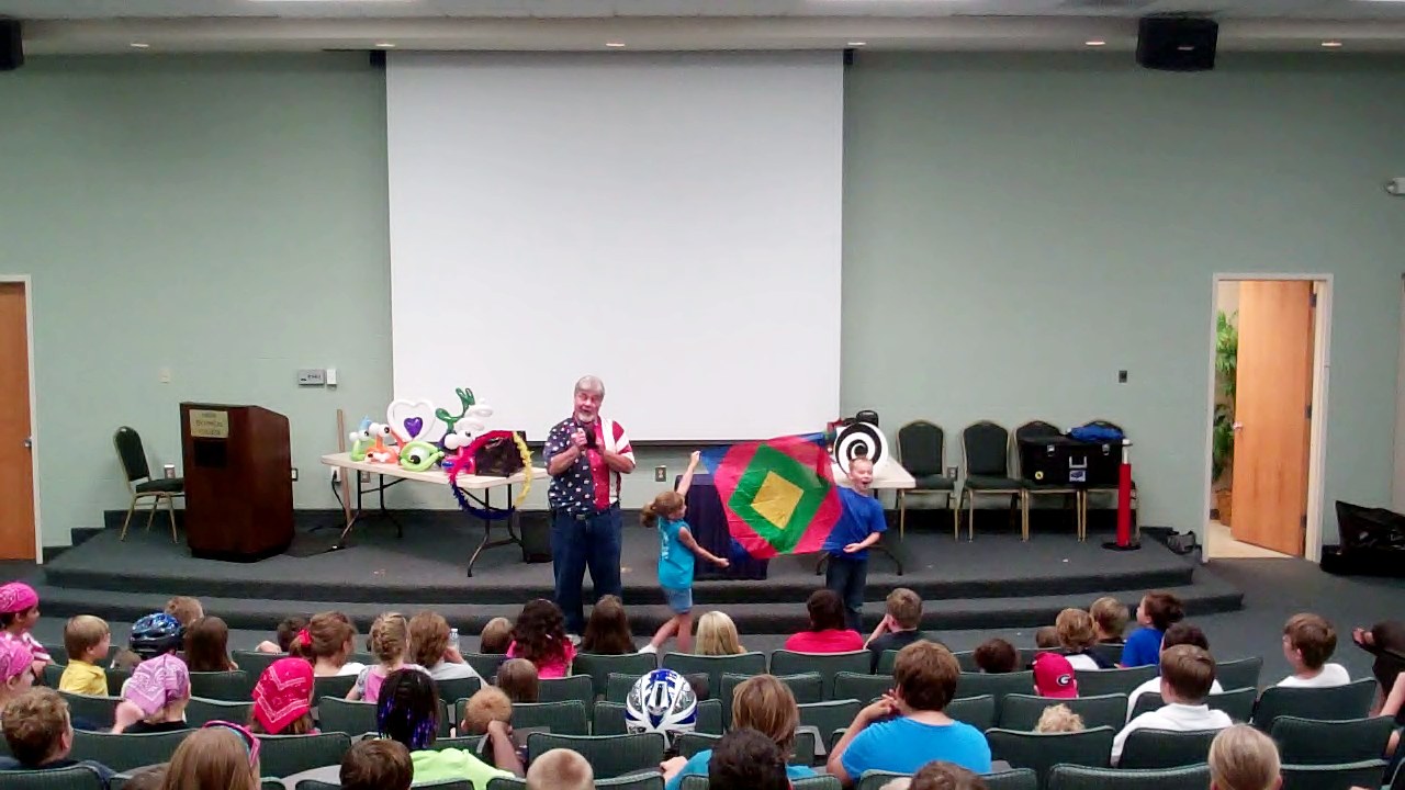 Uncle Sam performing a family-friendly illusion for kids and parents